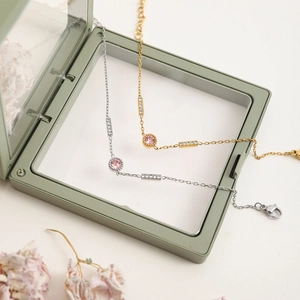 Detail of pink crystal bracelets with cubic zirconia accents in gold and silver finish