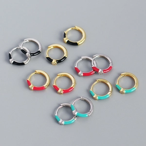 Detailed macro view of colorful enamel mini hoop earrings with micro-inlaid gemstones