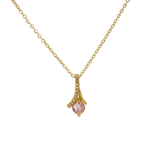 Detail of gold necklace featuring a round pink gemstone pendant with sparkling diamond halo