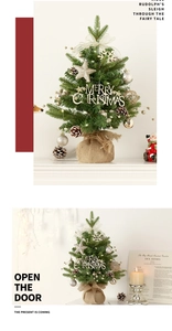 Close-up of mini Christmas tree with LED lights, golden ornaments and burlap base