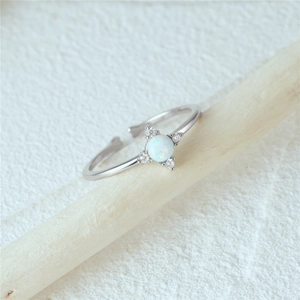 Macro detail of S925 silver adjustable ring with round opal and zircon accents