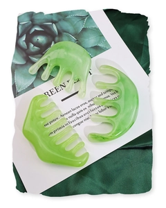 Detailed macro view of green resin massage combs with marble texture on an elegant background
