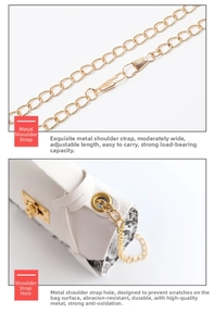 Detail of adjustable gold chain strap and snake pattern texture on a white leather bag
