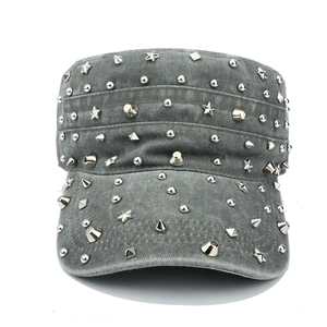 Close-up of vintage washed grey military cap featuring various silver punk style metal studs