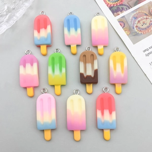 Detailed view of colorful resin ice cream popsicle charms with gradient finishes and metal rings