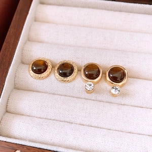 Detail of vintage resin round earrings with gold frames and sparkling crystals