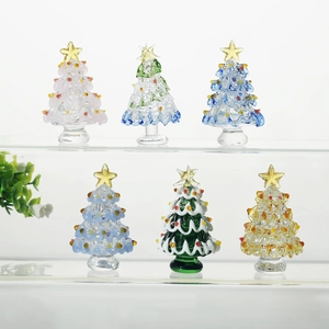 Set of six handcrafted colorful glass Christmas trees with gold stars for desktop decor