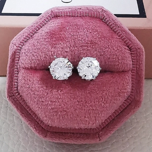 Macro shot of cubic zirconia butterfly stud earrings in a pink velvet jewelry gift box