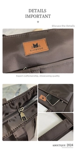 Detail of dark brown tote bag showing side phone pocket and reinforced stitching on handles