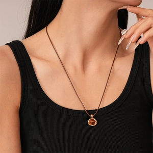 Vintage resin oval stone necklace with gold organic frame on a brown leather cord