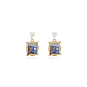 Close-up of golden frame earrings with ocean oil painting and elegant pearls