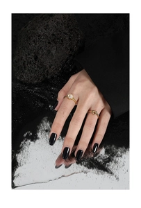 Close-up of S925 silver knot ring and moonstone band on model in industrial setting