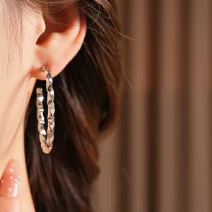 Polished silver geometric C-shape earrings for women with a modern faceted metal finish