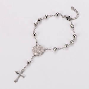 Polished silver stainless steel bracelet featuring St. Benedict medal and cross pendant