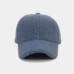 Close-up of textured blue sherpa fleece fabric on minimalist warm winter baseball cap