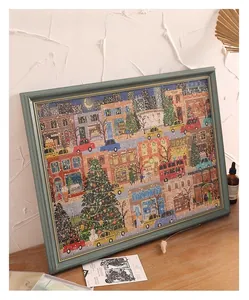 Detail of vintage blue wood frame showcasing a winter street scene art and Christmas theme
