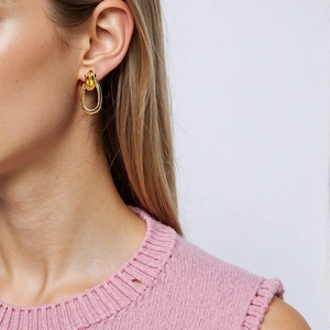 Fashionable twisted oval 18k gold plated stainless steel stud earrings on model