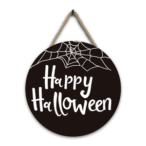 Close-up of Halloween wooden sign with white Happy Halloween text and spider web details