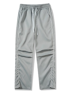 Detail of grey athletic pants with elastic drawstring waist and white side stripes