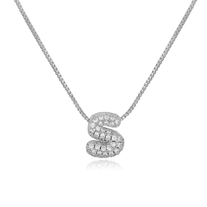 Close-up of silver-tone bubble letter S pendant with micro-paved cubic zirconia gems