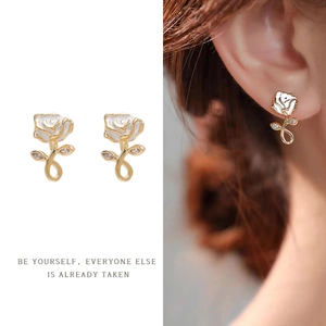 French vintage rose pearl earrings with white petals and gold stems on female model