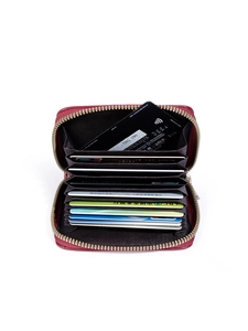 Detail view of burgundy leather accordion card holder with ten internal slots and metal zipper
