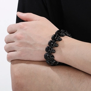 Close-up of black skull links on a vintage titanium steel bracelet for men