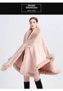 Close-up of pink knit poncho featuring plush faux fur collar and elegant hem detailing