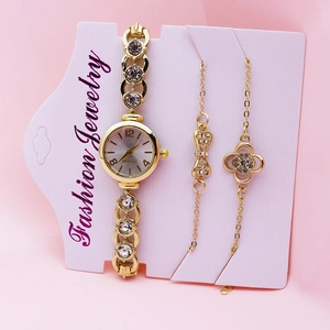 Close-up of elegant gold women's quartz watch with matching crystal bracelet jewelry set