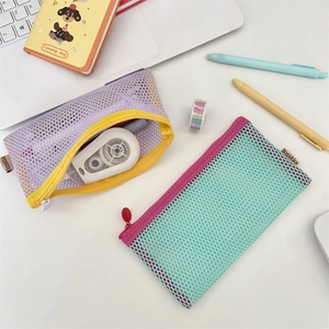 Detail of high-capacity mesh pencil pouches in contrasting purple and mint green colors