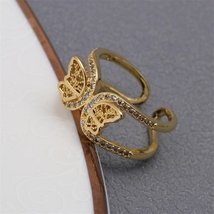 Adjustable gold butterfly ring with white cubic zirconia pavé in a minimalist style
