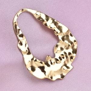 Detailed macro view of gold-plated 304 stainless steel pendant with hammered texture