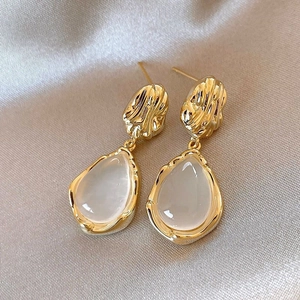 Elegant gold drop earrings with hammered texture and pear-shaped white moonstone