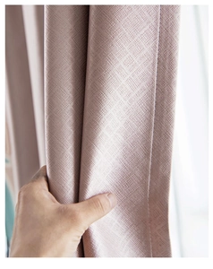 Close-up of pink blackout curtain fabric showing high-density weave and thick texture