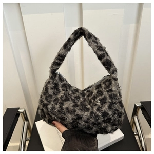 Close-up of leopard print plush handbag with top handle and secure zipper closure