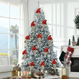 Red Christmas gnome ornaments with white dots hanging on a snow-covered pine tree