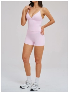 Pink two-piece yoga set featuring a V-neck cropped tank top and high-waisted gym shorts