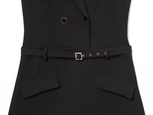 Detail of black mini dress with gold metal buckle belt and symmetrical flap pockets