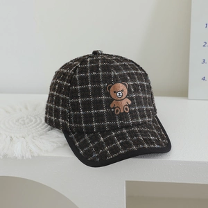 Close-up of brown plaid wool baseball cap for kids with cute 3D teddy bear patch