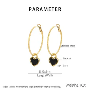 Detail of gold stainless steel hoop earrings with black enamel heart charm and dimensions