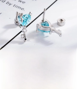 Detail of silver heart key stud earrings with blue zircon and titanium steel dimensions