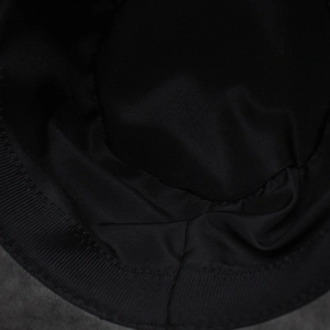 Detail view of the black cowboy hat interior featuring a ribbed sweatband and fine stitching
