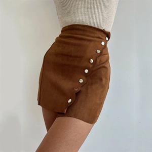Close-up of brown suede mini skirt featuring high waist and metal button details