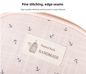 Detail of pink canvas storage bag with anchor pattern and reinforced stitching