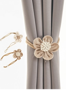 Detail of handmade burlap flower curtain tieback with faux pearls and jute petals