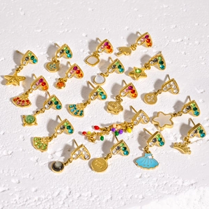 Golden stainless steel earrings collection with colorful crystals and varied shapes