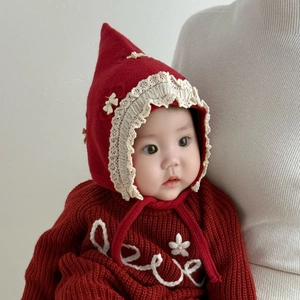 Red Nordic knit baby beanie with bow and earflaps set for winter warmth and style