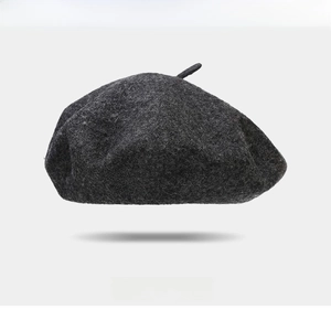 Detail of grey wool beret with red heart embroidery and comfortable fabric texture