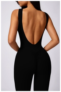 Detail view of the deep V open back and ruched booty design on black yoga bodysuit