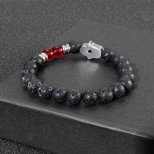 Lava stone bead bracelet with Hamsa Hand pendant on black matte jewelry box display